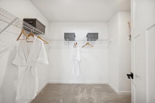 (Photo of a decorated model, actual homes finishes will vary) Primary bedroom walk-in closet.