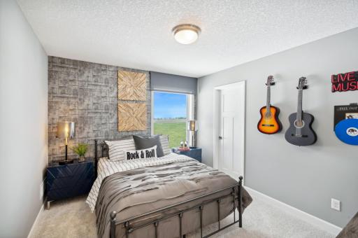 (Photo of a decorated model, actual homes finishes will vary) Another upper level secondary bedroom.