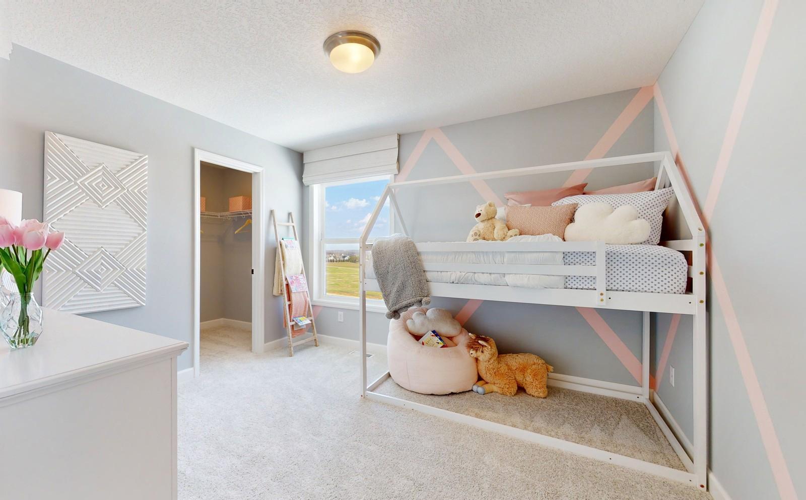 (Photo of a decorated model, actual homes finishes will vary) The third upper level secondary bedroom.