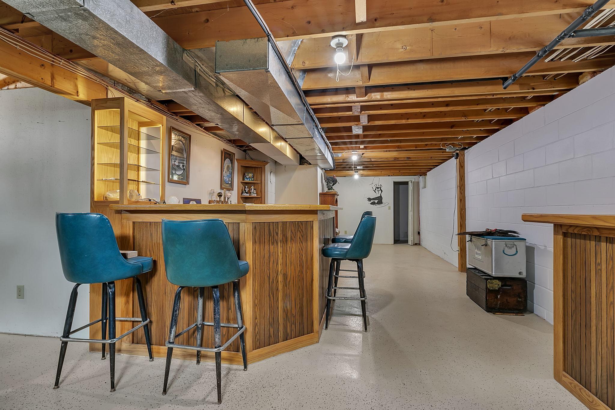 The dedicated lower-level bar area is prepped and ready for the finishing stage—a ceiling and a few minor touches are all that remain. This space invites you to sit a while, daydream, and easily personalize the final finishes to your exact taste!