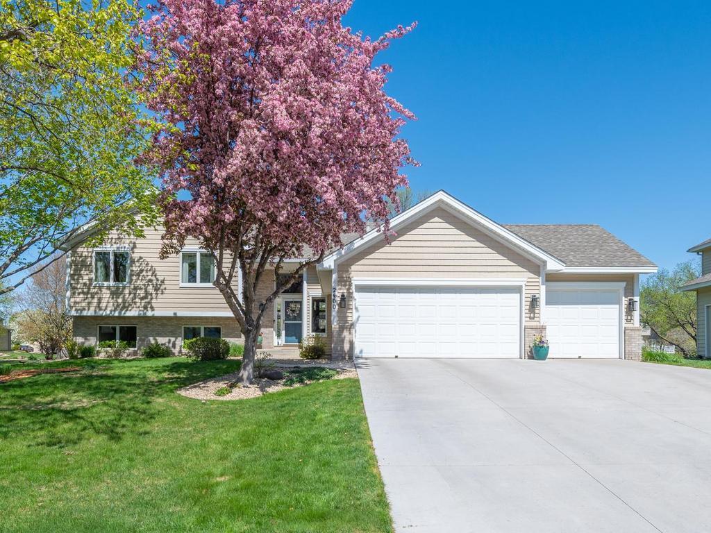 Tastefully selected shrubs and perennials handsomely surrounded by rock and woodchips in the front, back and sides. Love the exterior from every angle…and your new concrete driveway!