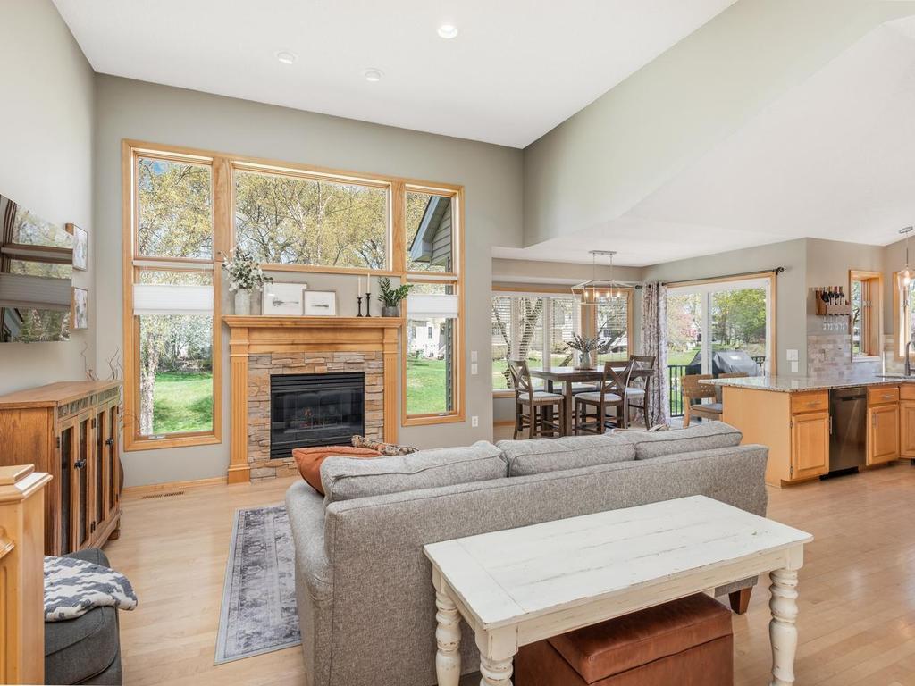 This living room is 17’6” x 14’4” featuring a wall of windows, new stone surround on the gas fireplace, recessed lighting and newer bottom-up/top-down window blinds.