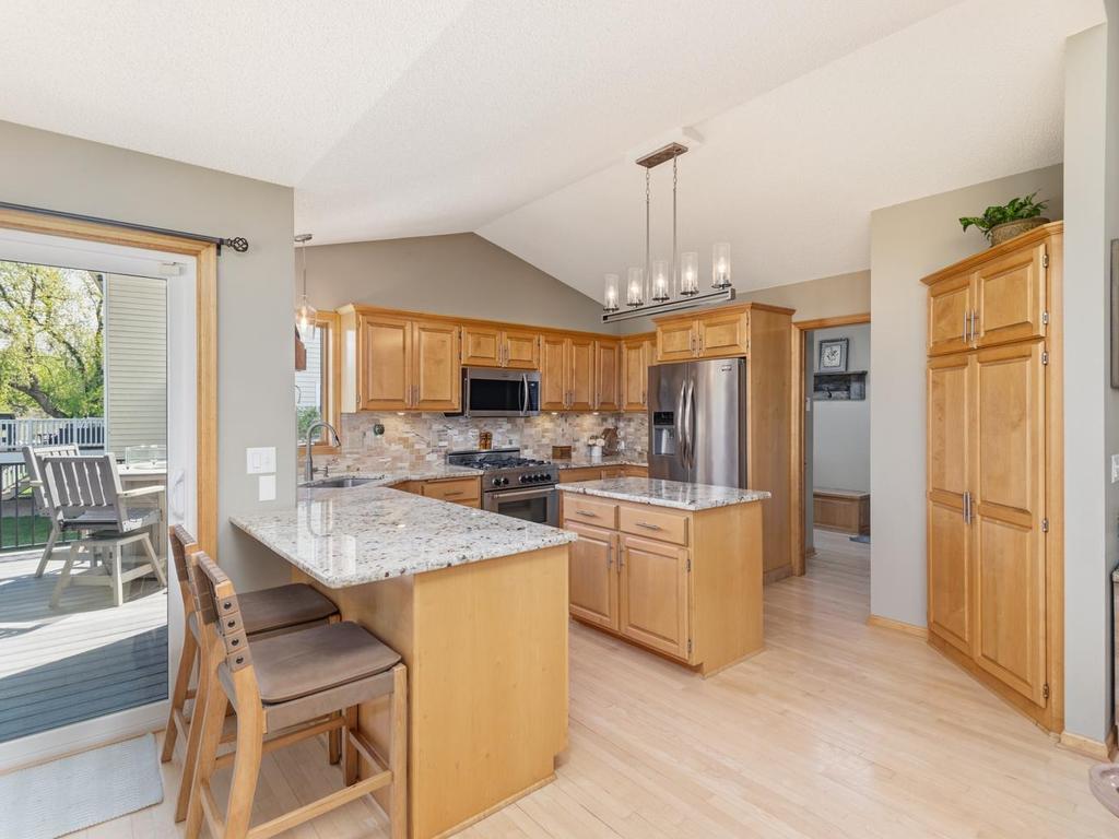 Be allured by the beautiful maple woodwork throughout the home. The kitchen features new granite countertops and backsplash. The breakfast bar is a perfect perch for snack time while watching TV in your adjoining living room.