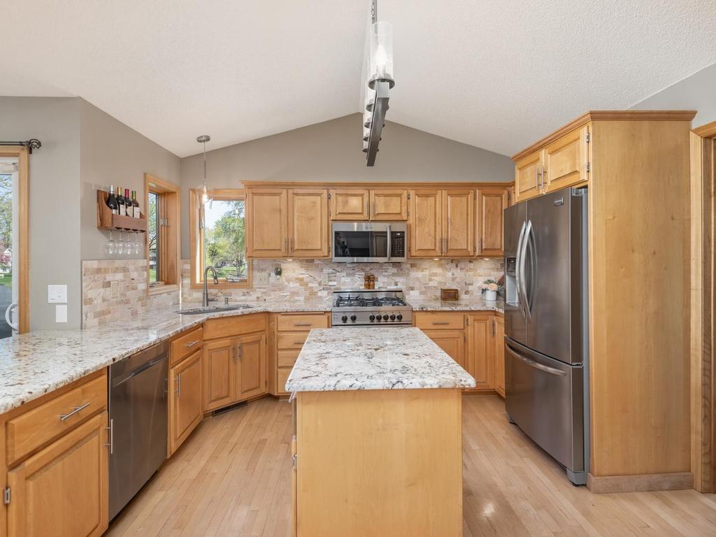 Two windows over your sink give you views of your lovely yard. Kitchen boasts under cabinet lighting, high end Italian Bertazzoni gas range, newer SS appliances including French door refrigerator w/ice maker, microwave, dishwasher & garbage disposal.