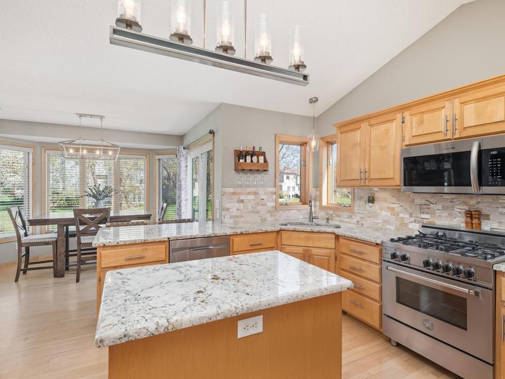 Notice the stylish kitchen island lighting as you look toward your dining room and the bay window. Love the abundance of light that floods your main level, or filter the light with your new window treatments.