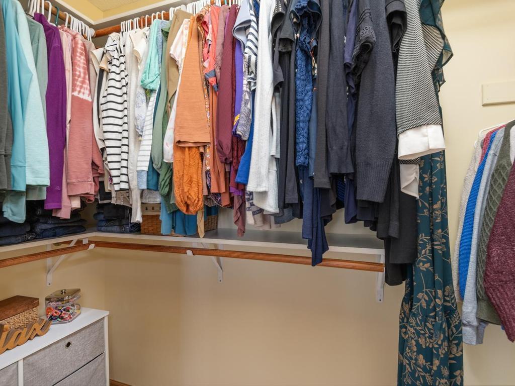 The closet is equipped with upper and lower hanging areas for efficient storage.