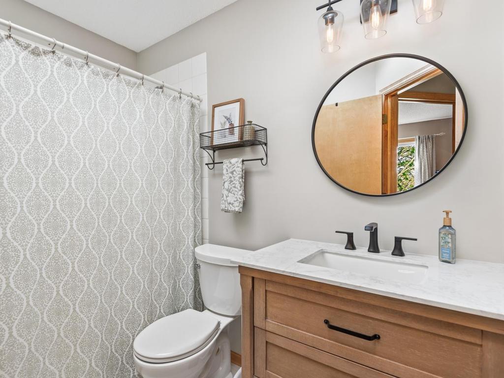 2nd full bath features new vanity, floor tile, shower head, faucet, light fixture and toilet. This bathroom also showcases an overhead skylight that fills the space with natural light.