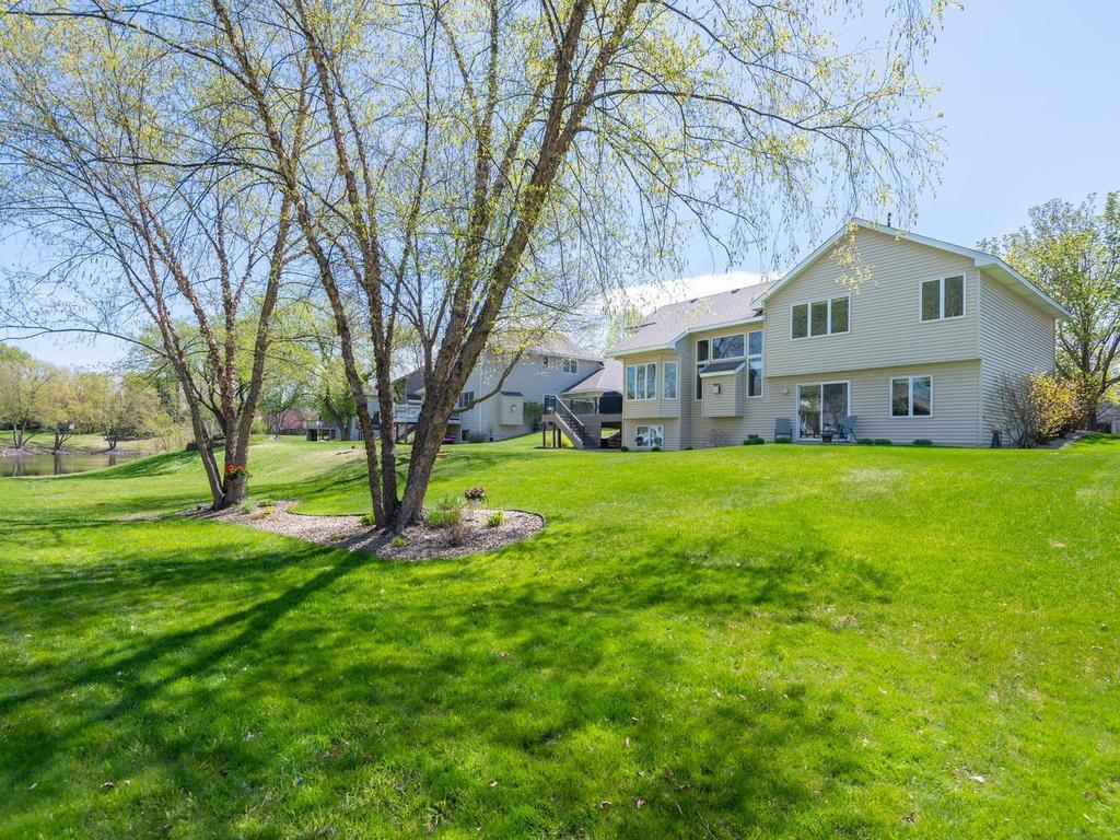 Take in the beauty of the vibrant green backyard and serene outdoor surroundings.