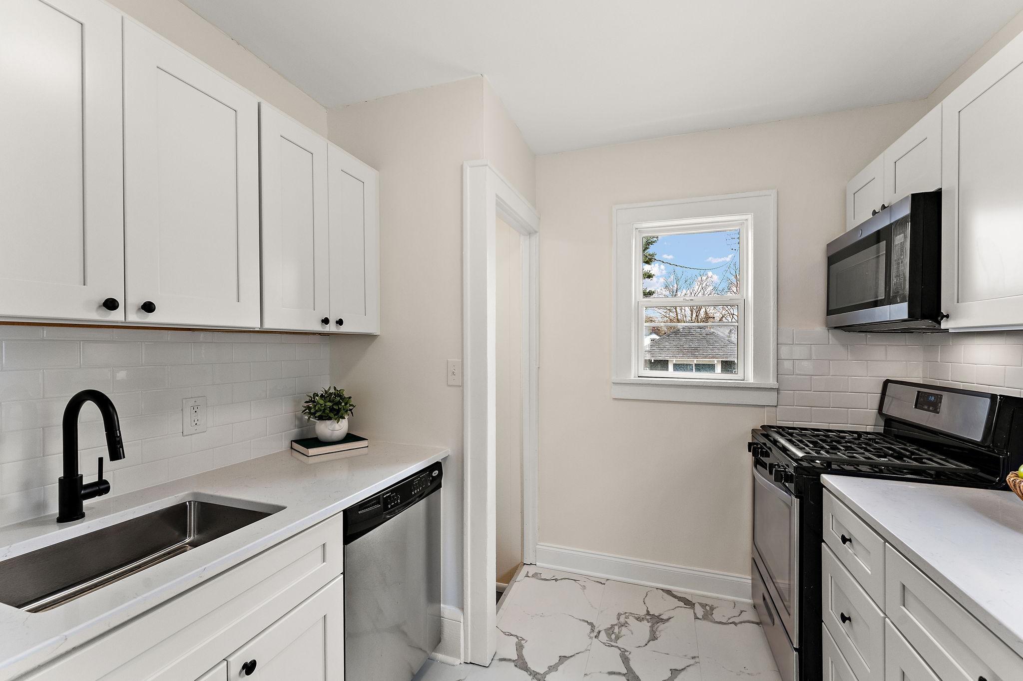 Beautiful remodeled kitchen with quartz countertops and stainless steel appliances!