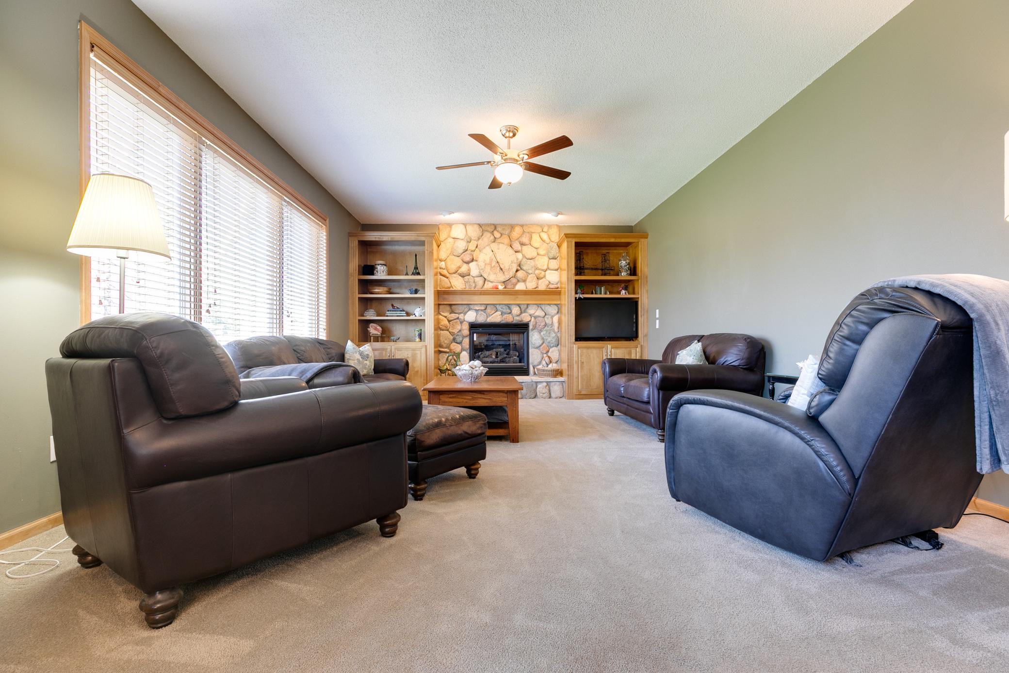 The gas fireplace with a stone-surround in the family room creates the perfect setting for warm and cozy evenings during the colder months.