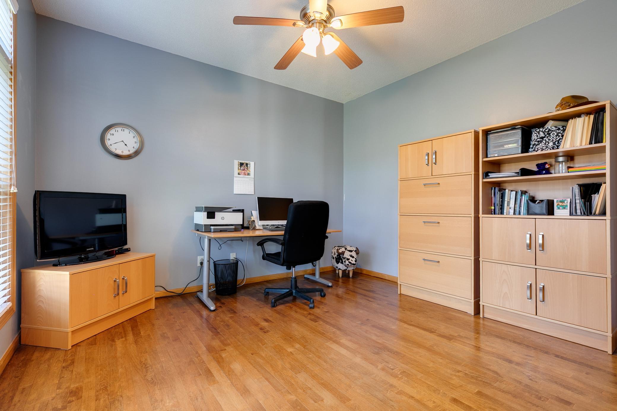 Main floor office room with ceiling fan.
