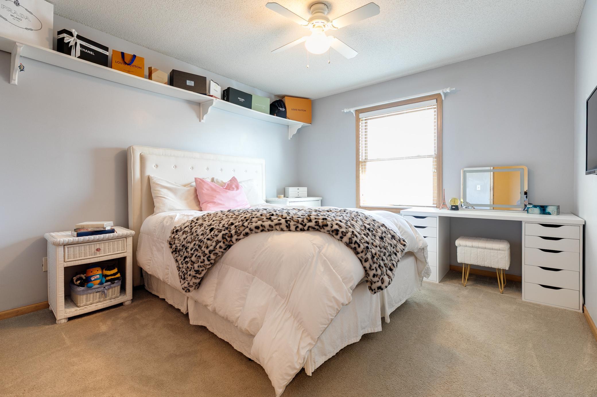 The upper level has four bedrooms and a full bathroom. The mounted TV with remote in this bedroom will be included with the property.