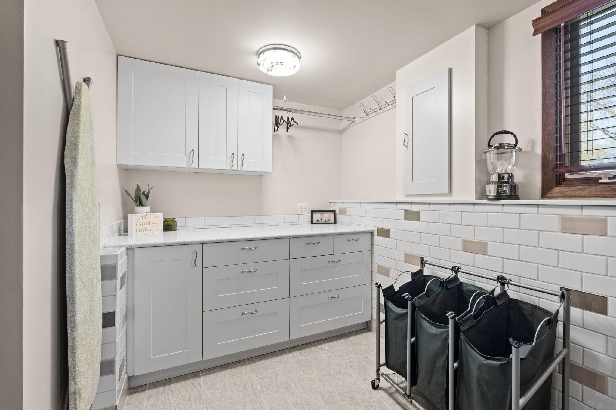 Bonus - MORE cabinet storage, hanging rack, and folding space in laundry room!