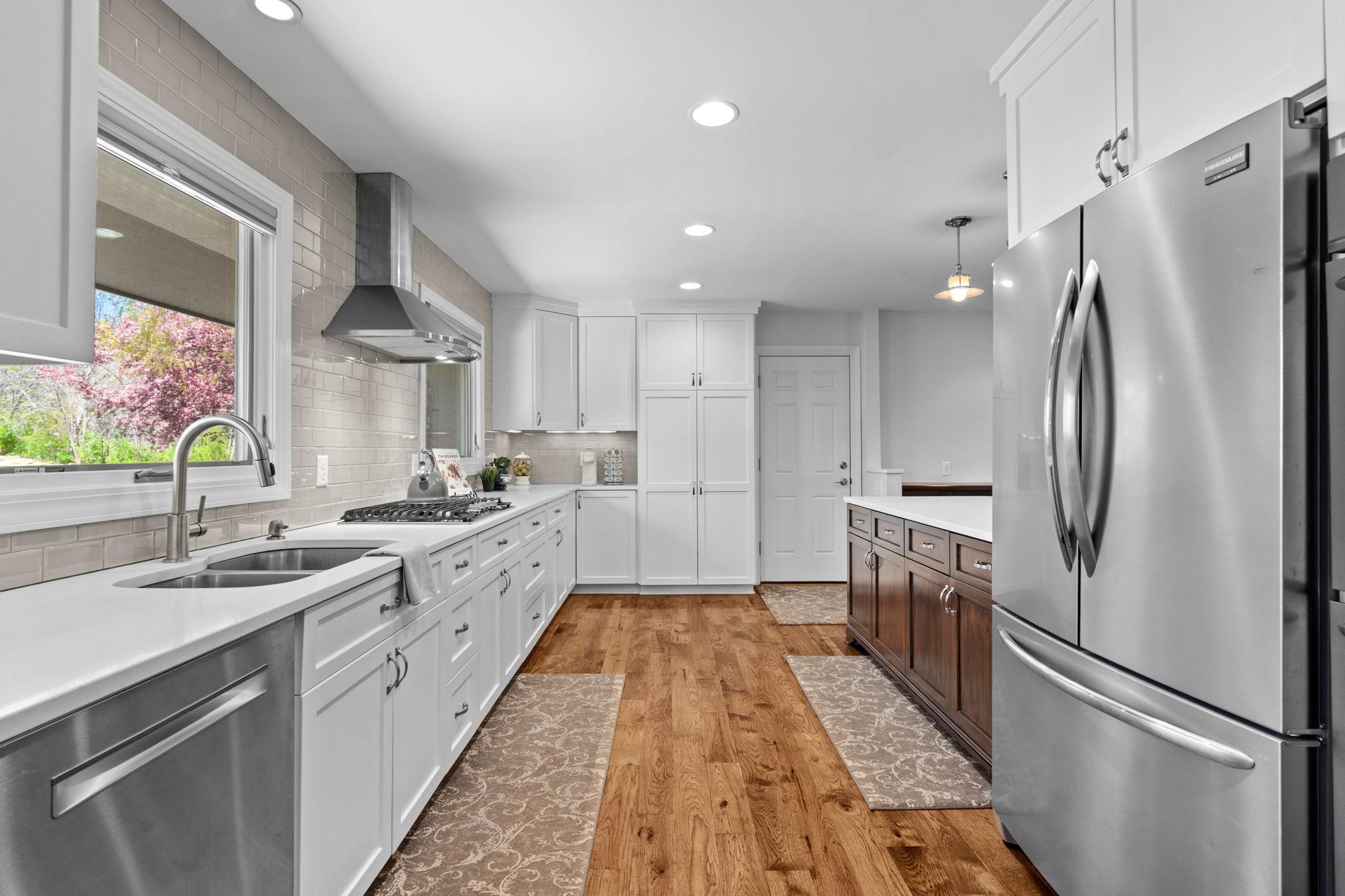 Wide walk way makes it easy for multiple people to cook at once in this space.