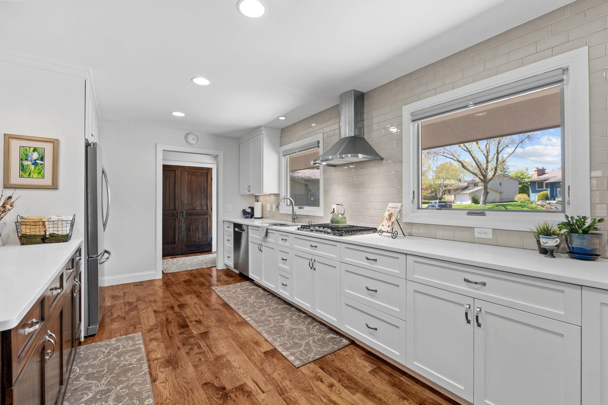 Imagine preparing all of your favorite meals in this space! Vented hood, cook top, large windows allow natural light to flood in to your cooking space.