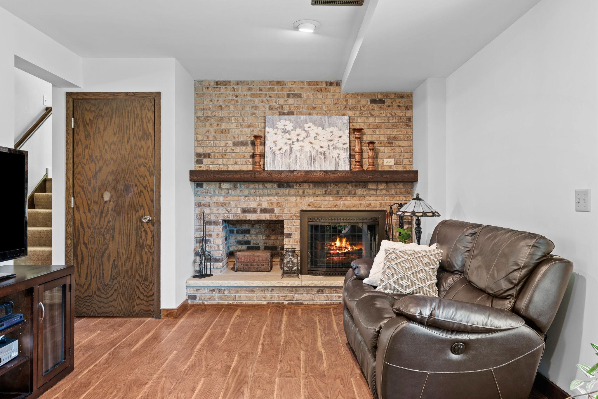 View of the wood burning fireplace in lower level.