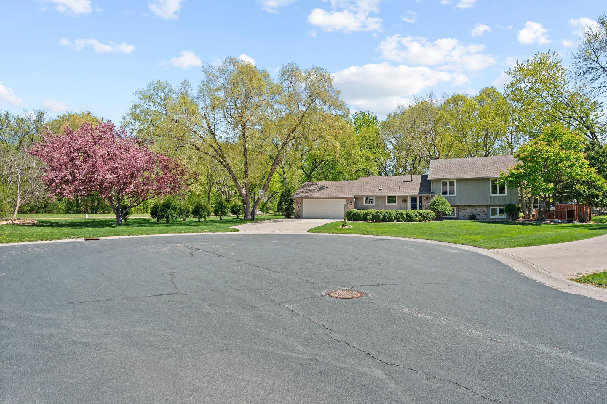 Right at the end of the cul-de-sac! Welcoming and well maintained landscaping to come home to.
