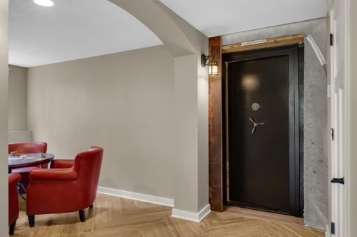 Behind a hidden vault door is a one-of-a-kind speakeasy or safe room. Perfect for entertaining and showcasing your collection.