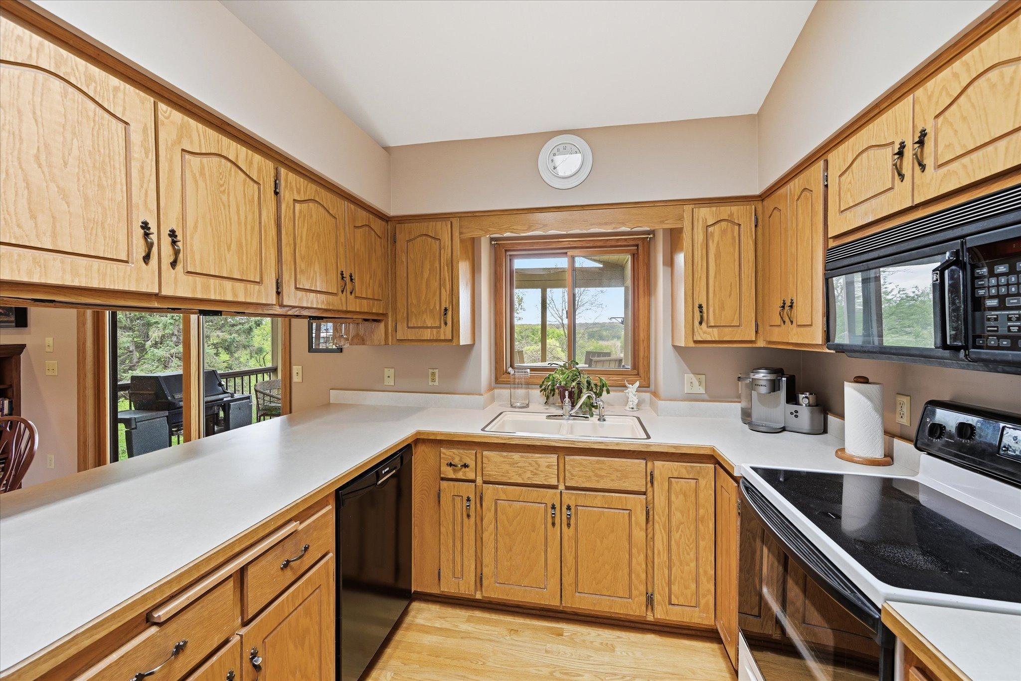 You might not even mind doing the dishes with this kitchen window view. New garbage disposal.