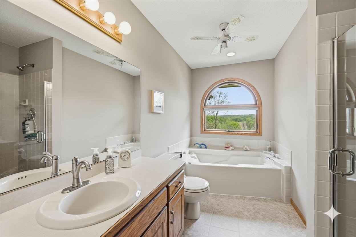 Main bath has whirlpool tub, shower and toe kick lighting under vanity. The large pretty window makes it bright and sunny and the perfect place to get ready in the morning. A fun custom laundry chute goes from the end of the cabinet to the laundry.