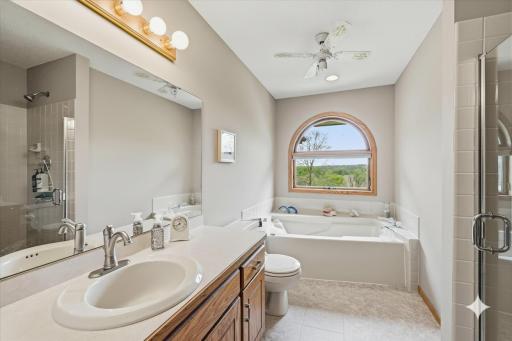 Main bath has whirlpool tub, shower and toe kick lighting under vanity. The large pretty window makes it bright and sunny and the perfect place to get ready in the morning. A fun custom laundry chute goes from the end of the cabinet to the laundry.