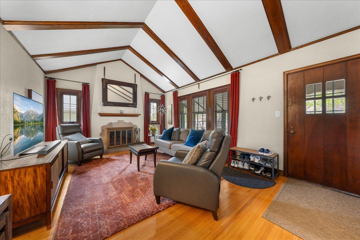 Vaulted Ceiling with Wood burning FP. Wood shuttered window treatment with velevet drapery. The front door is a beautiful sold original