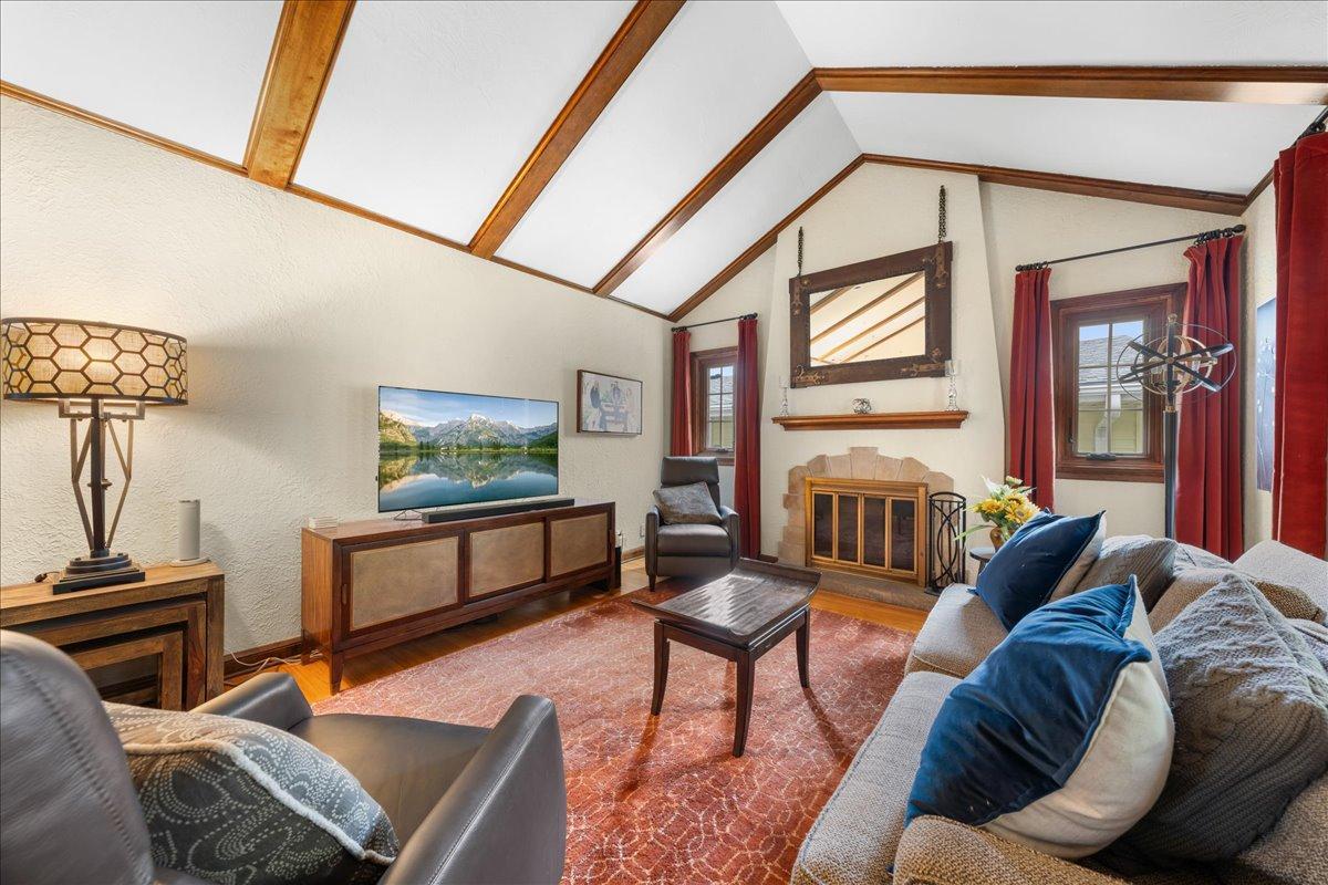 The Windows flanking the fireplace have been replaced with Anderson Renewal. The Mirror above the Mantel will not stay with the property