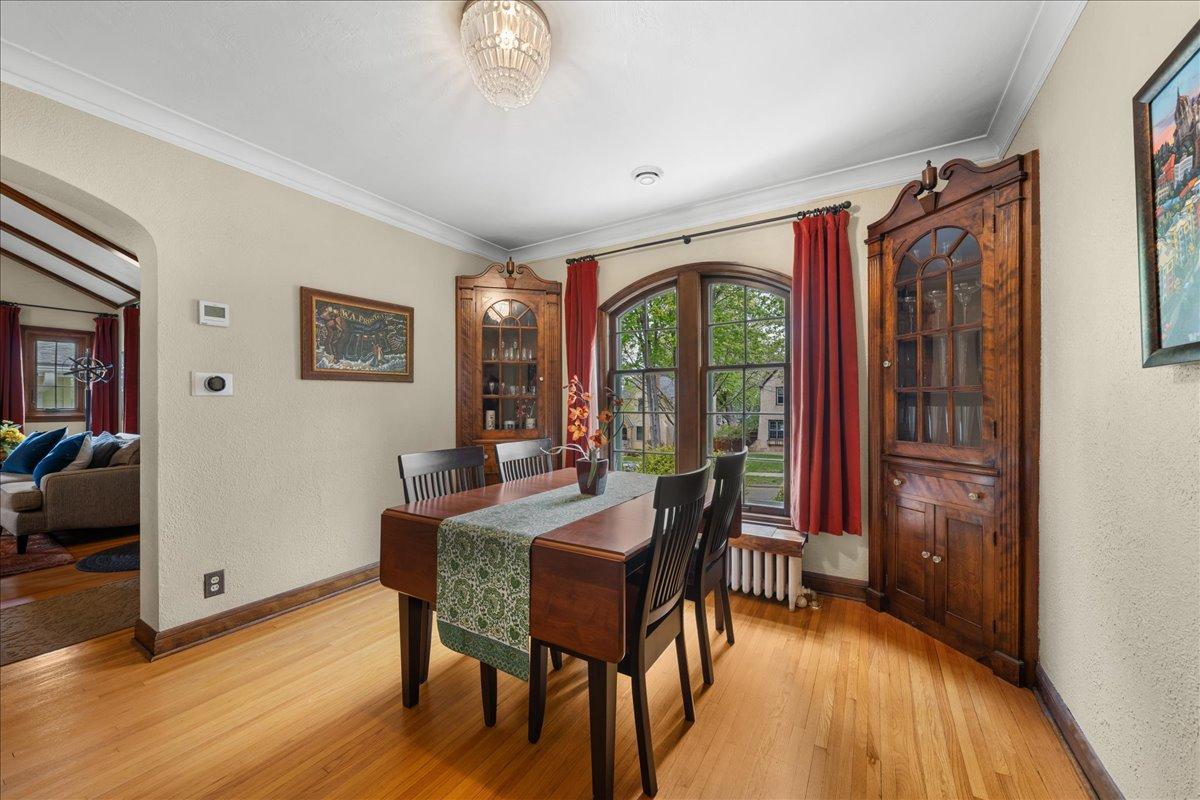 Original wood floors and curio built-ins add to the Tudor charm