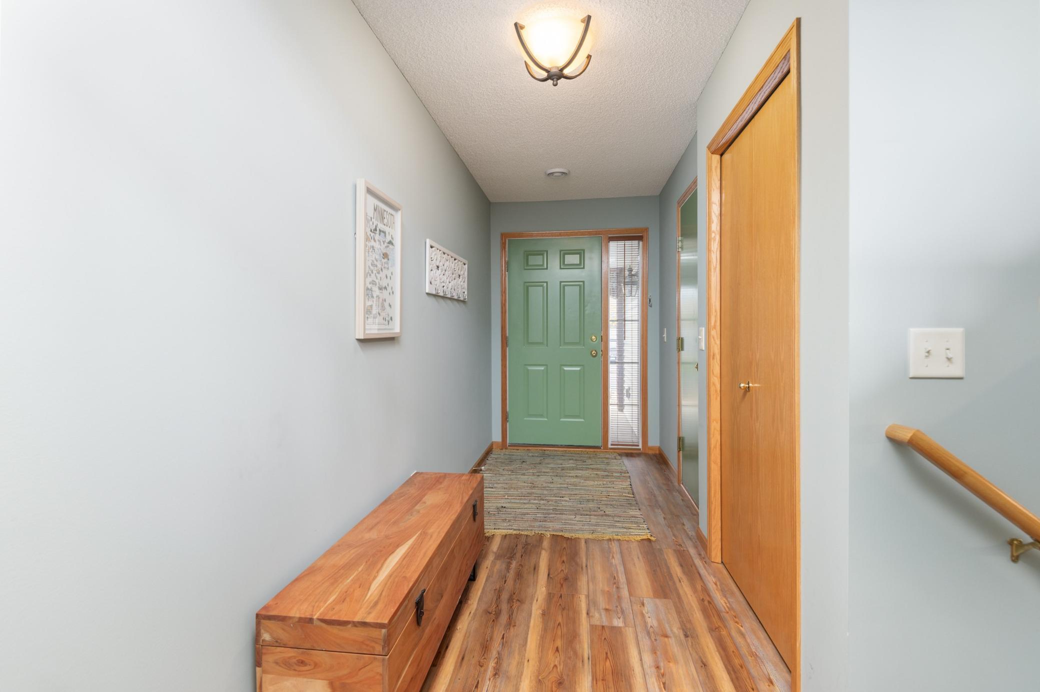 Entry with beautiful flooring and coat closet!