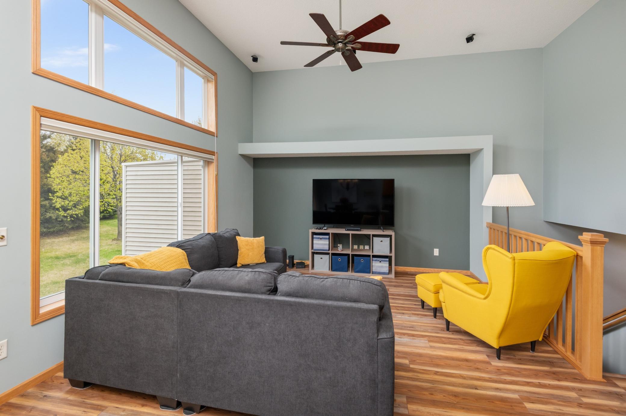2 story great room with large windows and beautiful flooring, ceiling can and perfect TV nook!