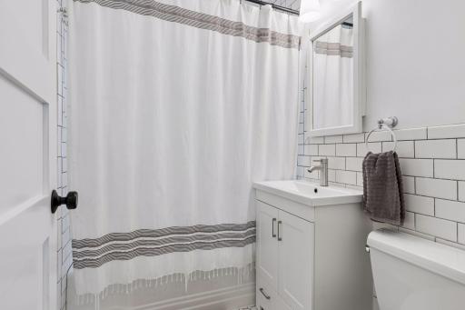 The main level full bathroom has been updated with subway tile, a new vanity and fixtures.