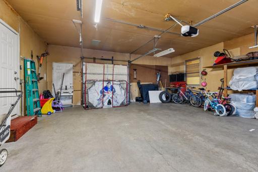 The spacious garage features an overhead garage door that opens to the backyard.