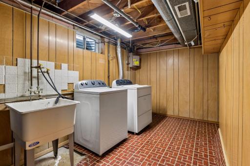 Tucked away behind the laundry room is a large, unfinished storage room.
