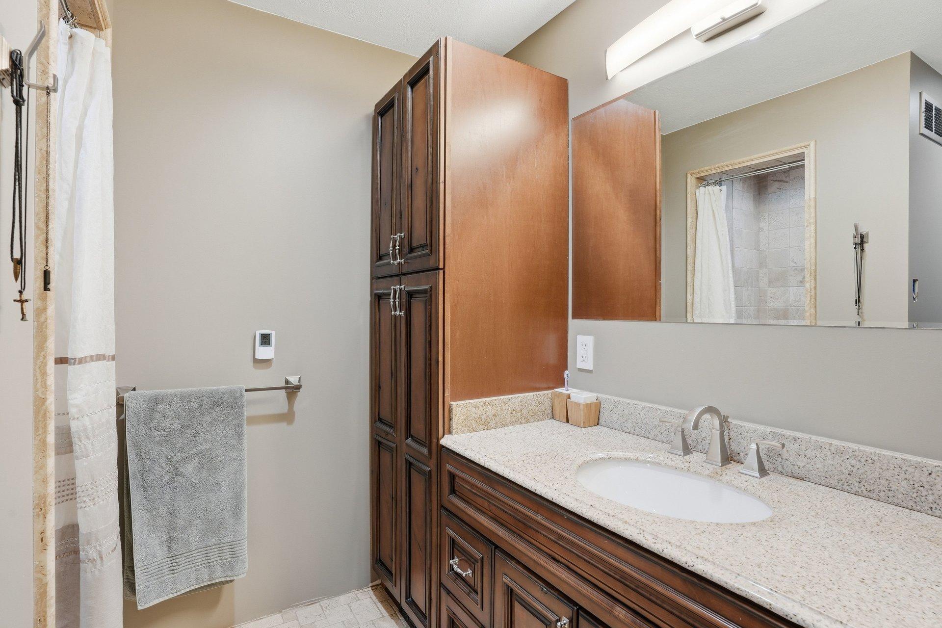 Fully renovated 3/4 bathroom featuring a beautiful walk-in tile shower, updated finishes, and a clean, modern feel.