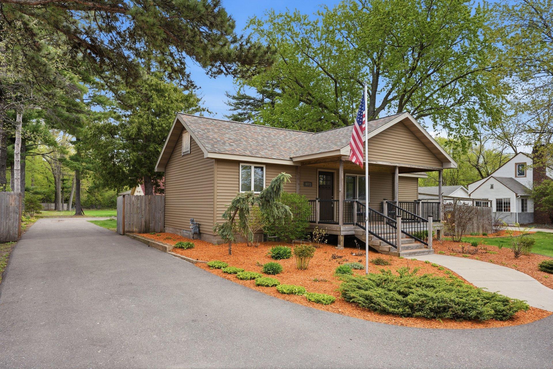 A long paved driveway leads to the garage area and is secured with fencing, offering added privacy, functionality, and plenty of space for parking, storage, or recreational use.
