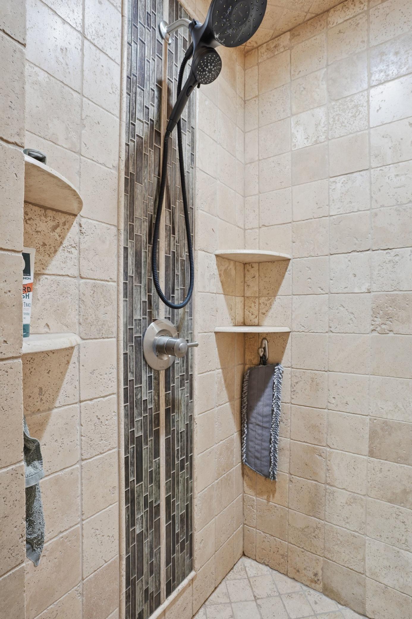 Fully renovated 3/4 bathroom featuring a beautiful walk-in tile shower, updated finishes, and a clean, modern feel.