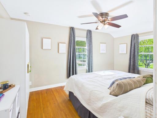 Spacious primary bedroom with ceiling fan and space for a king bed and nightstands.