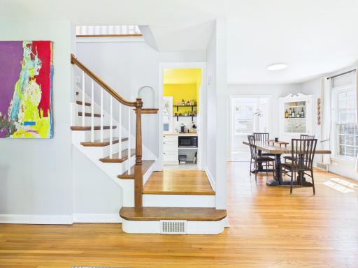 Elegant stairway with original wood banister and inset display cove.