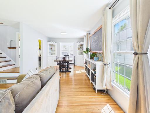 Living room expands to the formal dining room with built-in cupboards.