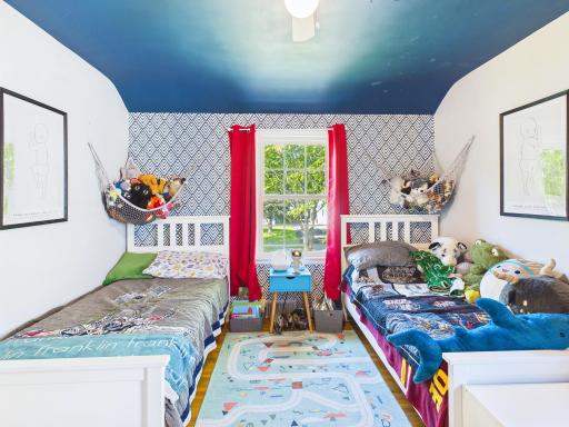 Adorable third bedroom with windows on two walls.