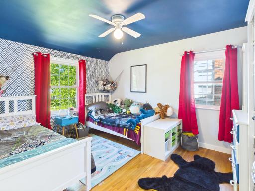 Coved ceilings, hardwood floors, accent wall make for an easy space for relaxation or play.