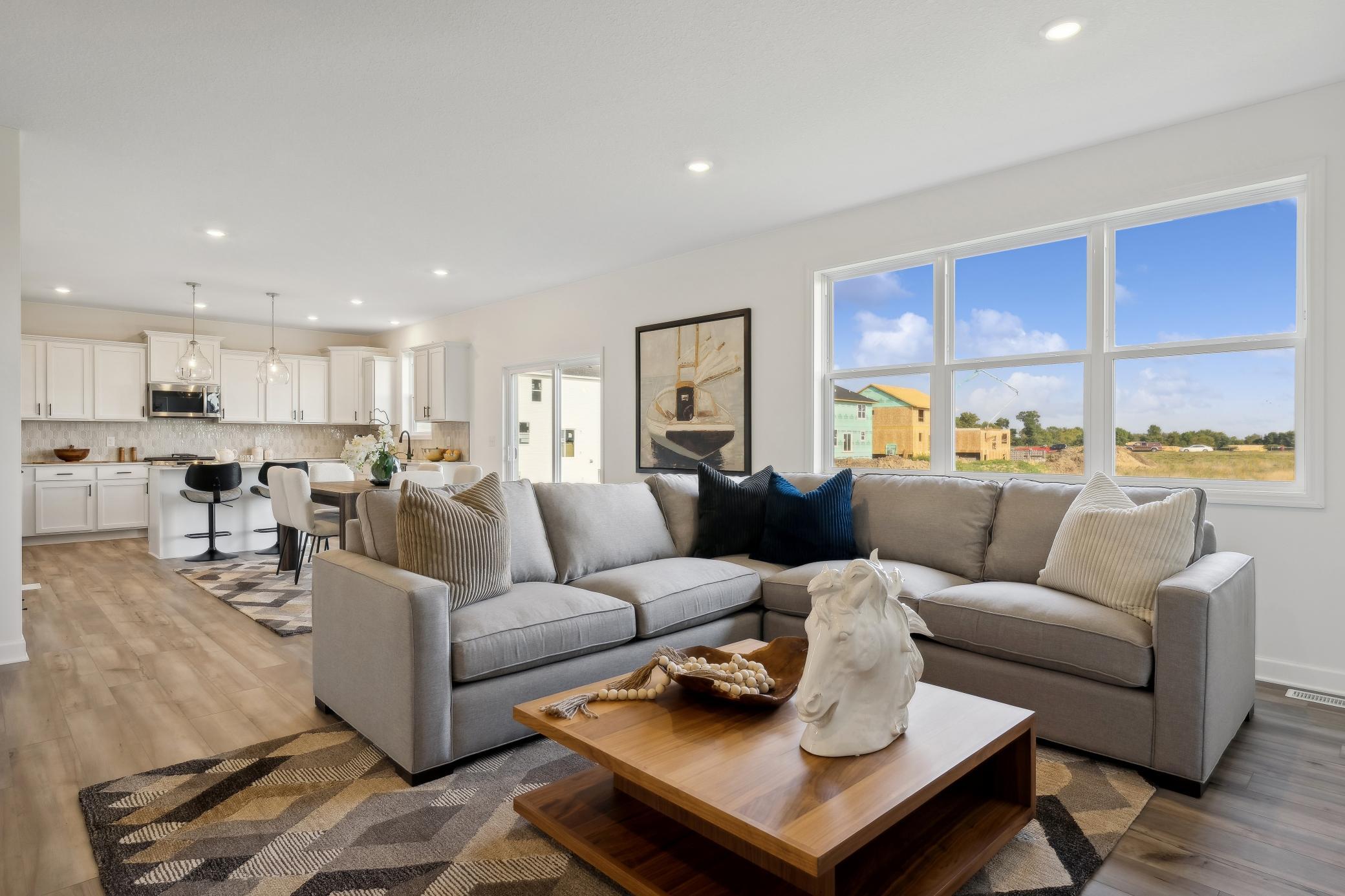 (Photo of decorated model, actual home's finishes will vary) The spacious and open-concept main level allows for optimal versatility and comfort.