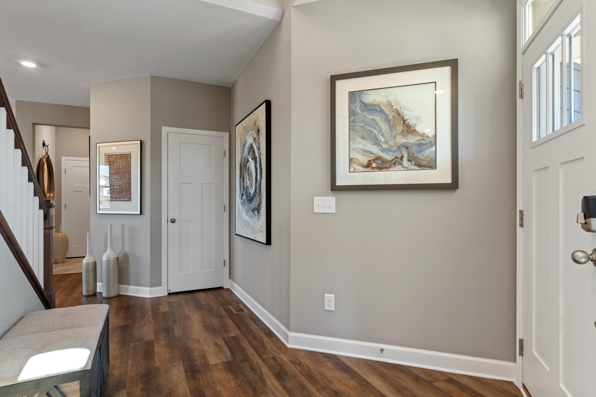 (Photo of decorated model, actual home's finishes will vary) The open entry to the home!