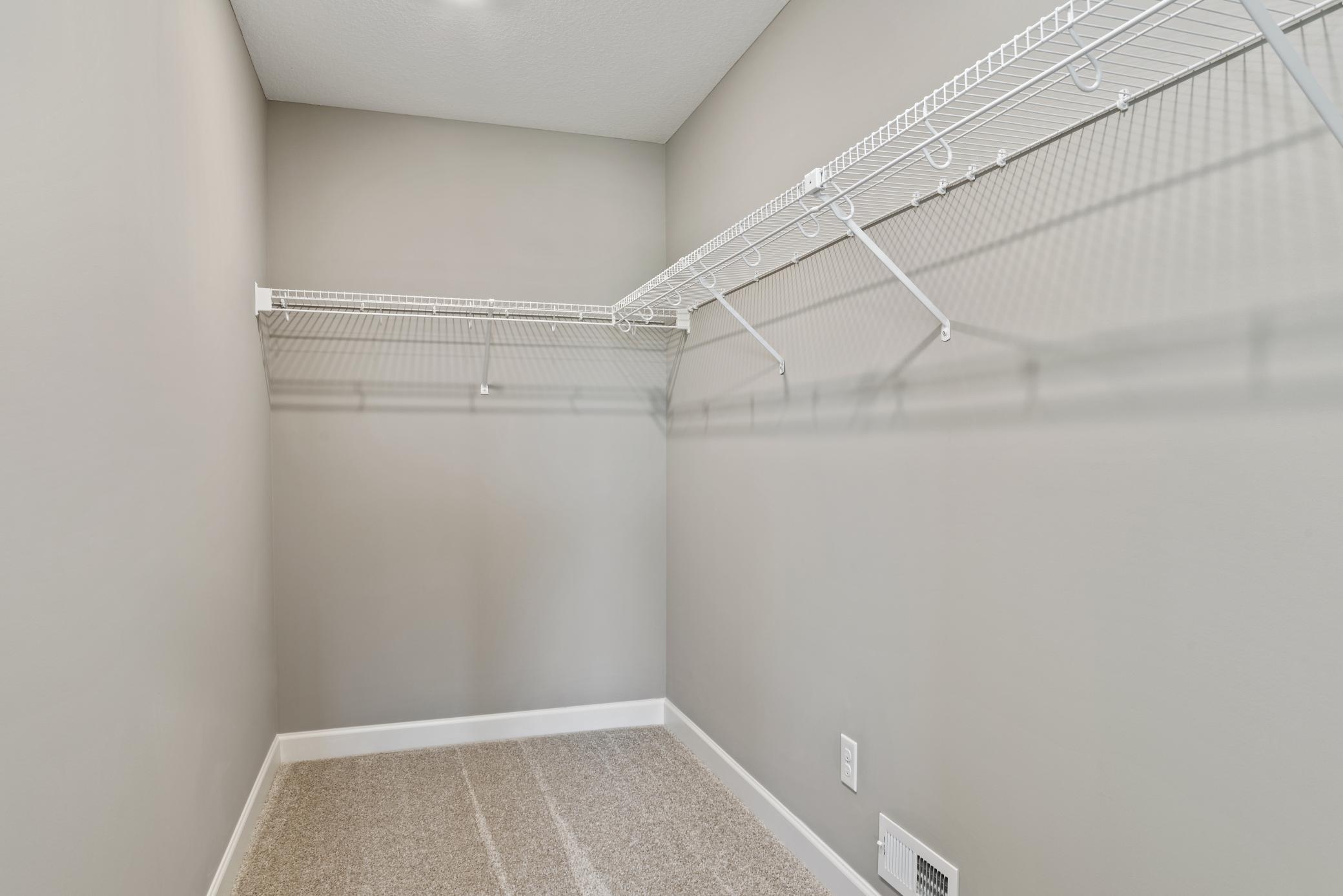 (Photo of decorated model, actual home's finishes will vary) A large walk in closet attached to the owners suite!