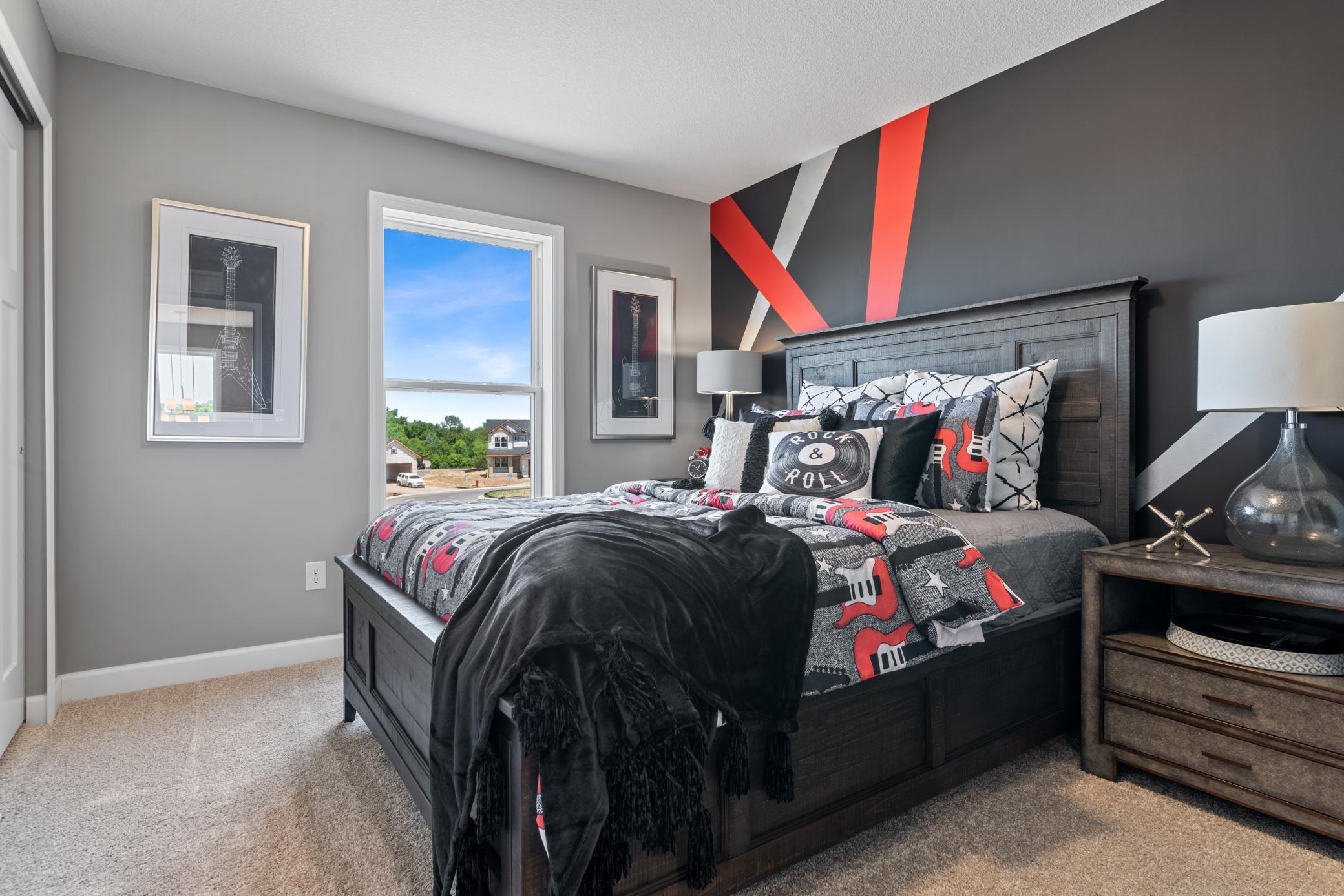 (Photo of decorated model, actual home's finishes will vary) One of the three spacious secondary bedrooms.