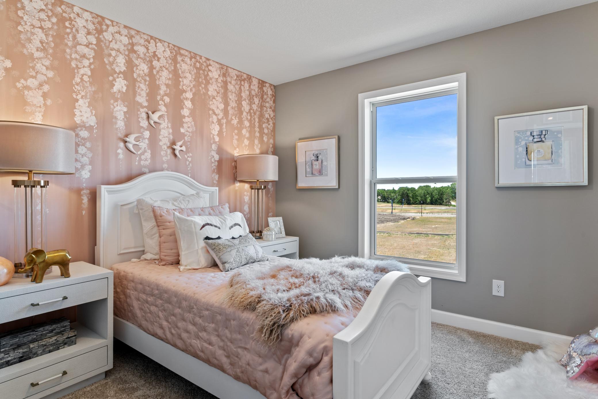 (Photo of decorated model, actual home's finishes will vary) The second spacious secondary bedrooms.