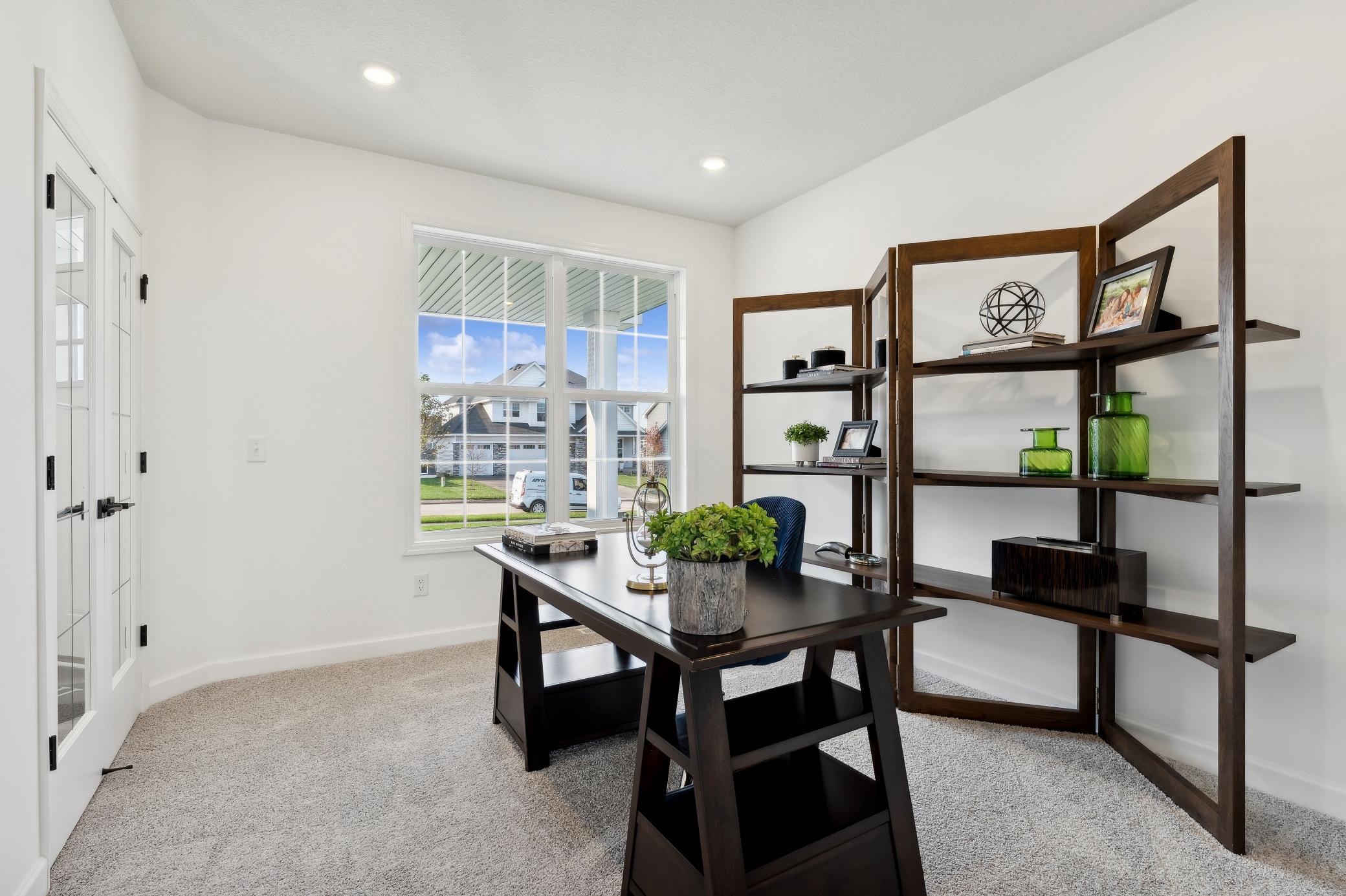(Photo of decorated model, actual home's finishes will vary) The versatile flex space with French doors