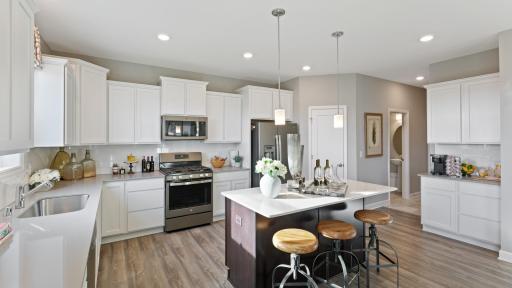 (Photo of decorated model, colors and features will vary) Thoughtfully designed kitchen with walls of cabinets and an abundance of storage.