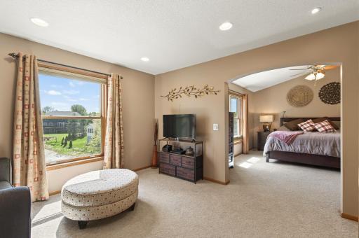 The primary suite is an impressive space, featuring its own private sitting room and large windows.