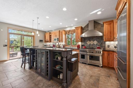 Chef-inspired gourmet kitchen features high-end appliances, a gas double oven, prep sink, and heated floors. Spacious granite counters provide all the room you need to prep, cook, and entertain in style.